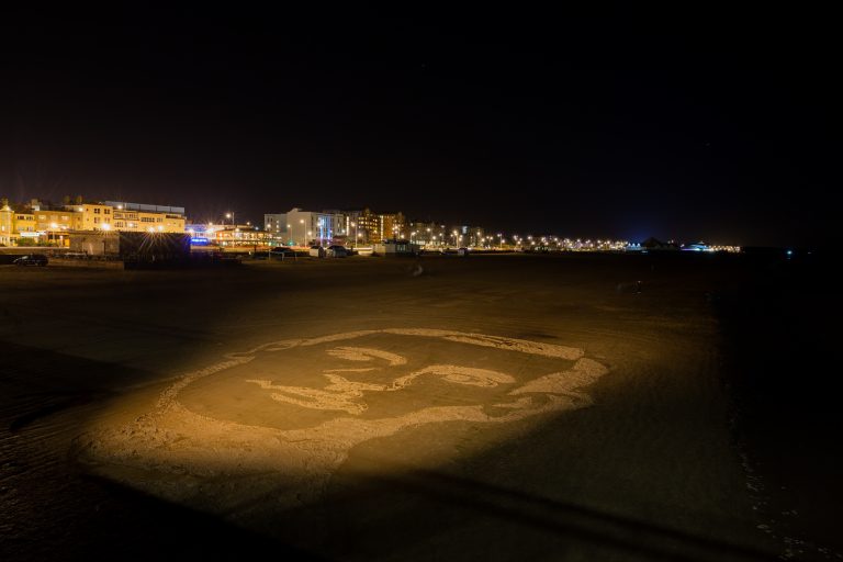 Pages-of-the-Sea-giant-sand-portrait-of-WW1-soldier-on-Weston-beach.night-image.picture-credit-Paul-Blakemore